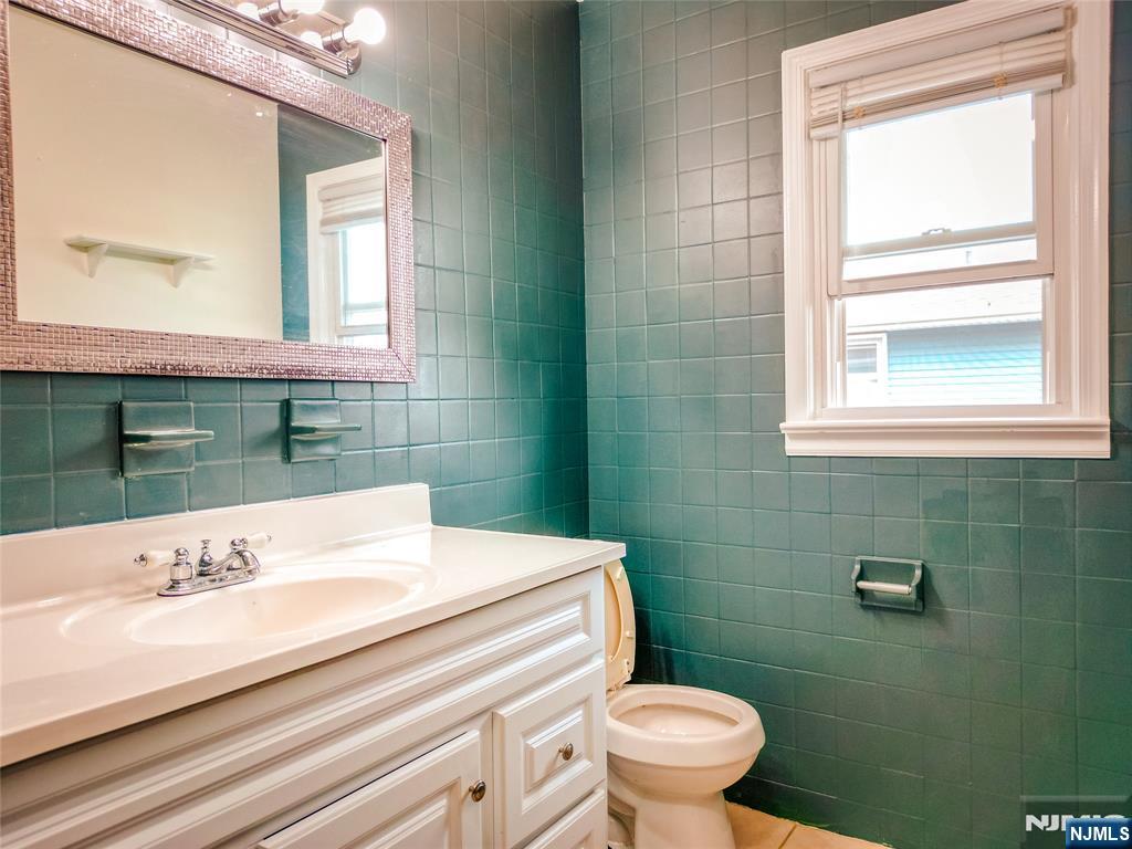 104 Eastern Way Rutherford, NJ 07070 - Photo 12 of 16 a bathroom with a sink a toilet and mirror