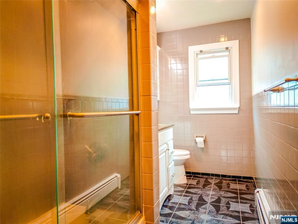 104 Eastern Way Rutherford, NJ 07070 - Photo 4 of 16 a bathroom with a toilet and a shower