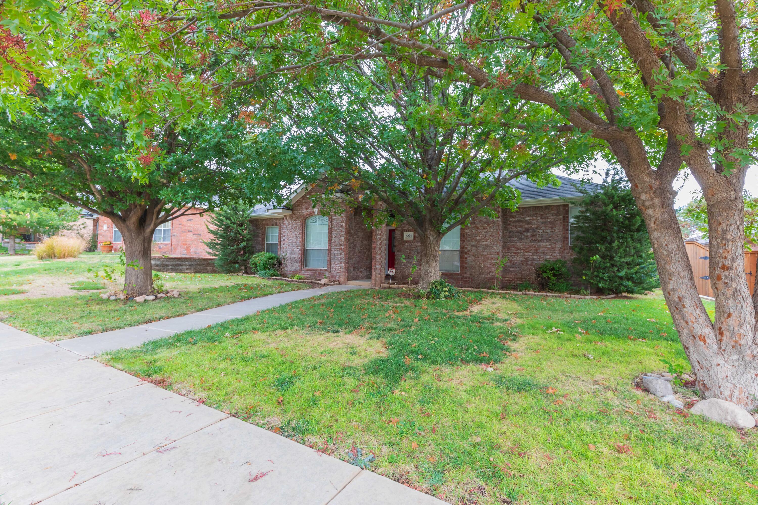 8505 San Antonio Drive Amarillo, TX 79118 - Photo 1 of 52 a backyard of a house with plants and large tree