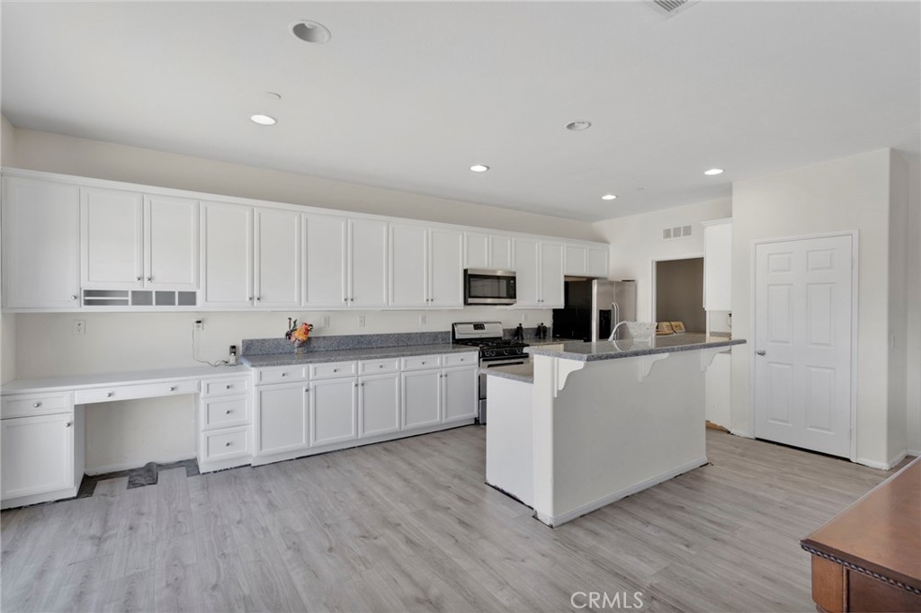 14245 Purple Canyon Road Adelanto, CA 92301 - Photo 11 of 38 a kitchen with white cabinets and sink