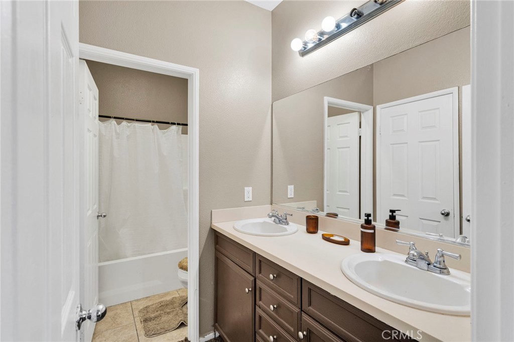 14245 Purple Canyon Road Adelanto, CA 92301 - Photo 19 of 38 a bathroom with a double vanity sink mirror and double