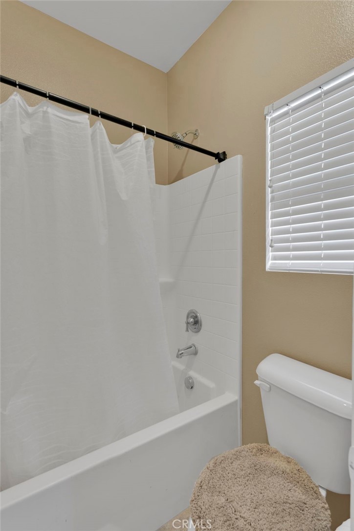 14245 Purple Canyon Road Adelanto, CA 92301 - Photo 21 of 38 a white toilet sitting next to a bath tub