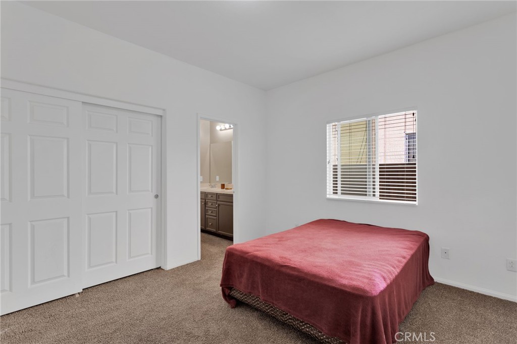 14245 Purple Canyon Road Adelanto, CA 92301 - Photo 23 of 38 a bedroom with a bed and a window