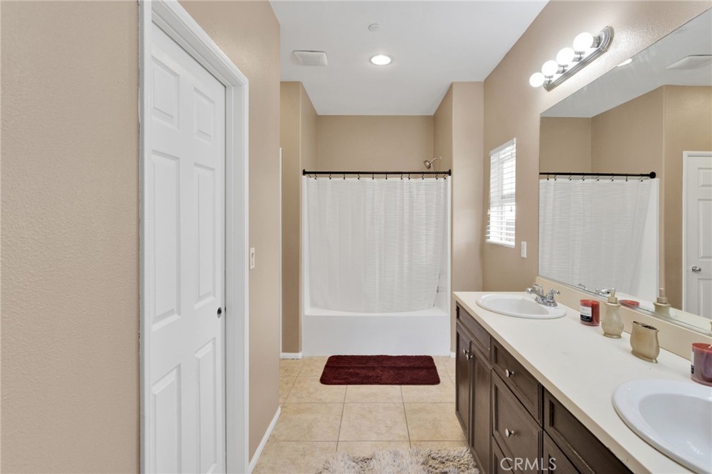 14245 Purple Canyon Road Adelanto, CA 92301 - Photo 28 of 38 a bathroom with a sink a double vanity and a mirror