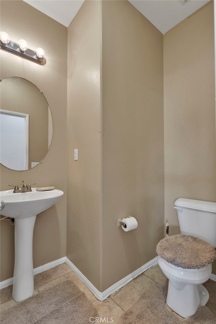 14245 Purple Canyon Road Adelanto, CA 92301 - Photo 32 of 38 a bathroom with a sink and a toilet