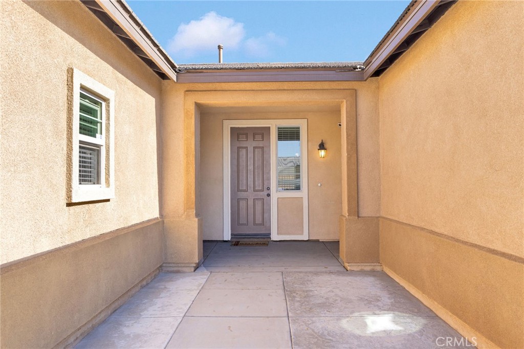 14245 Purple Canyon Road Adelanto, CA 92301 - Photo 4 of 38 a view of a hallway with a window