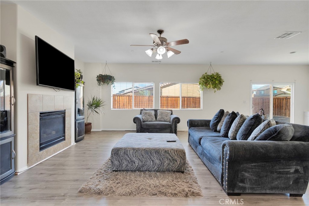 14245 Purple Canyon Road Adelanto, CA 92301 - Photo 7 of 38 a living room with furniture fireplace and flat screen tv