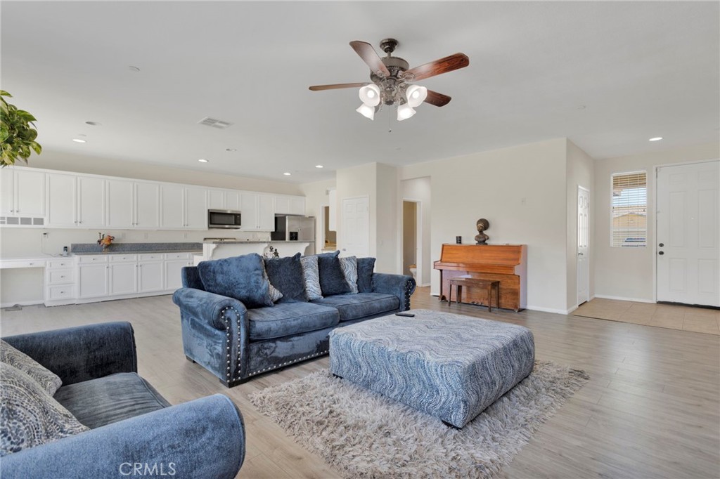 14245 Purple Canyon Road Adelanto, CA 92301 - Photo 8 of 38 a living room with furniture and wooden floor