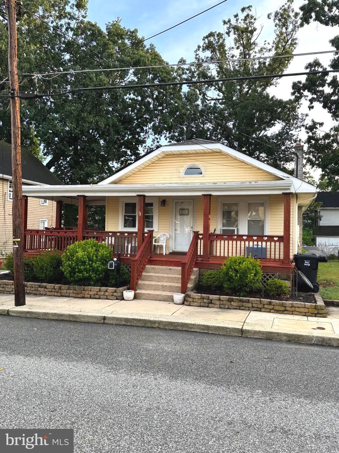 a front view of a house with garden and patio