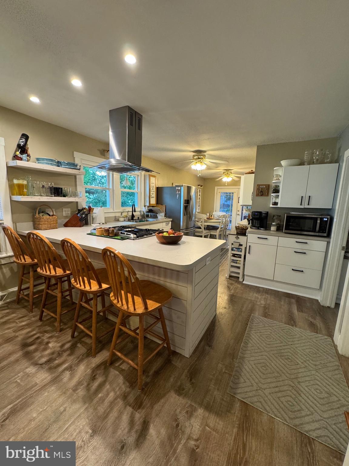 416 Wesley Avenue Pitman, NJ 08071 - Photo 13 of 47 a kitchen with stainless steel appliances kitchen island granite countertop a table chairs and a refrigerator
