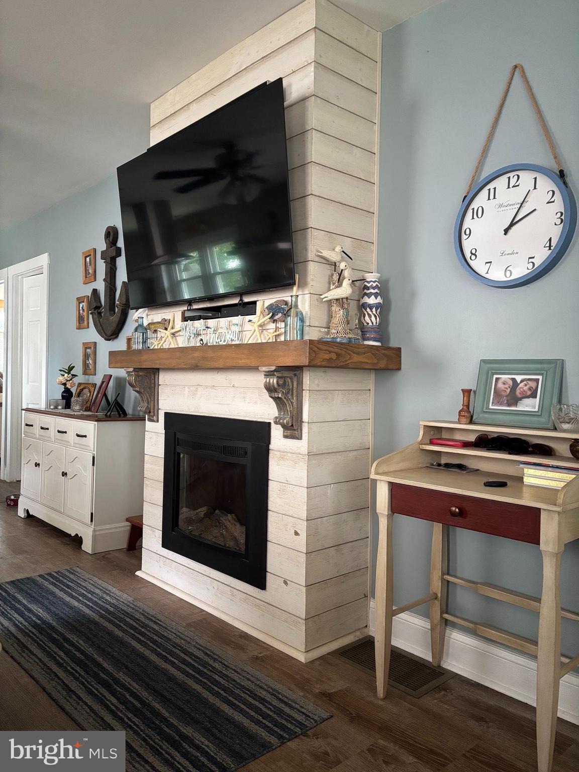 416 Wesley Avenue Pitman, NJ 08071 - Photo 29 of 47 a living room with a fireplace and a flat screen tv