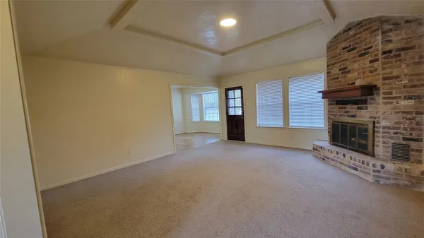 a view of an empty room with a fireplace