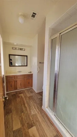 wooden floor with a bathroom