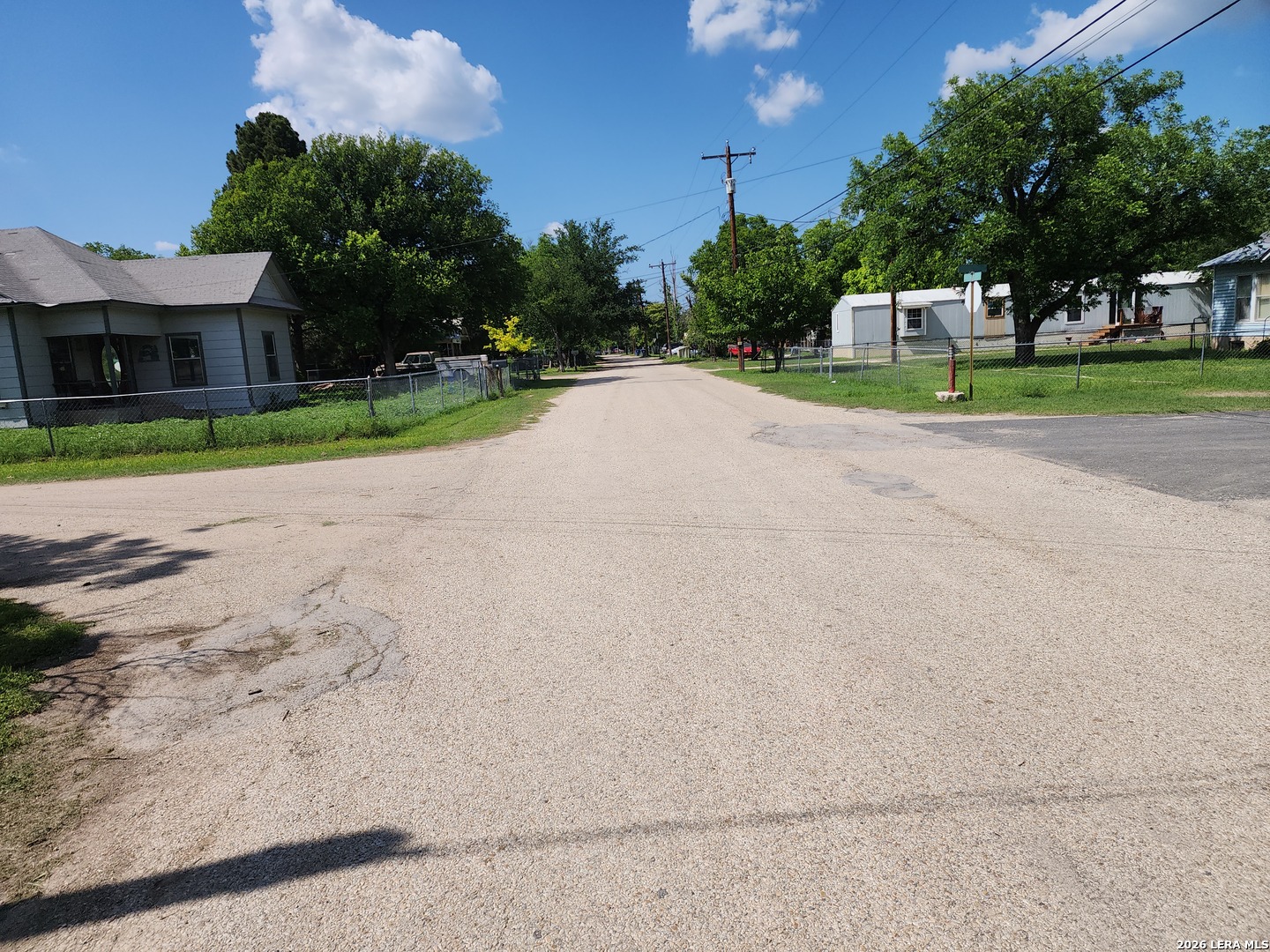 235 North 12th Street Junction, TX 76849 - Photo 5 of 14 a view of a house with a big yard and large trees