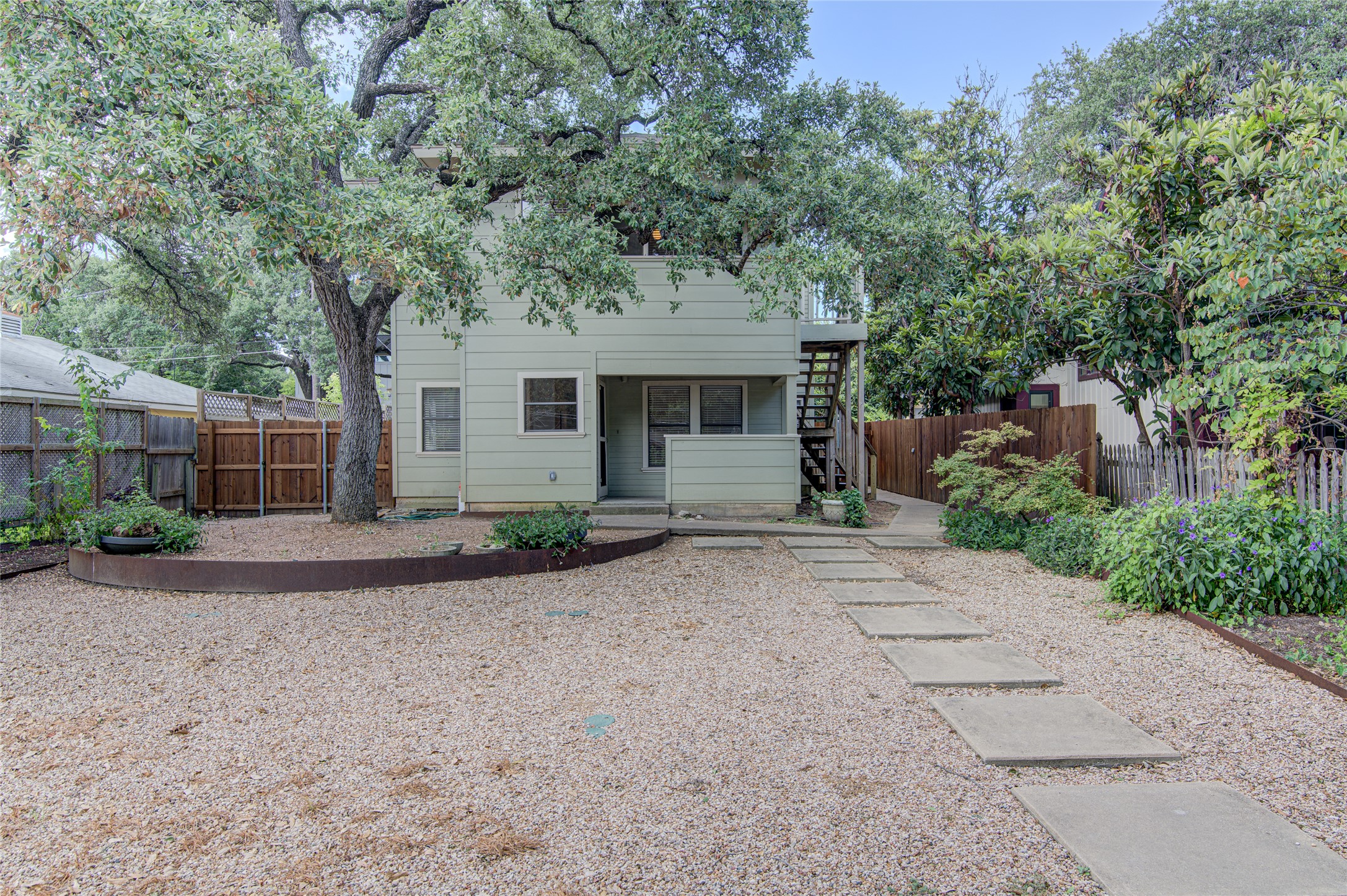 311 West Mary Street Austin, TX 78704 - Photo 1 of 35 A tranquil gravel yard provides a natural setting with stepping stone pathways and mature trees.