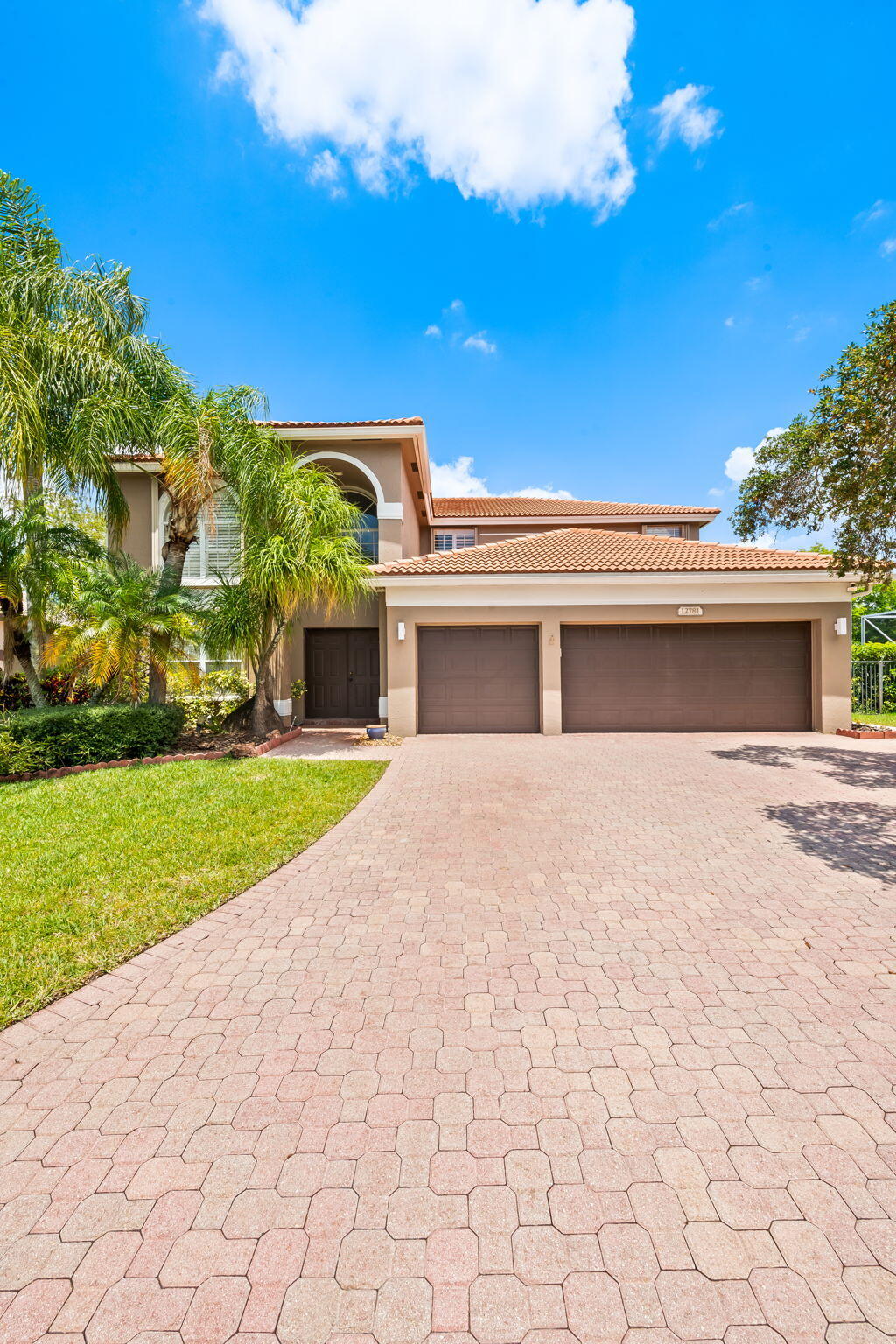 12781 Yardley Drive Boca Raton, FL 33428 - Photo 4 of 55 a front view of a house with a yard and garage