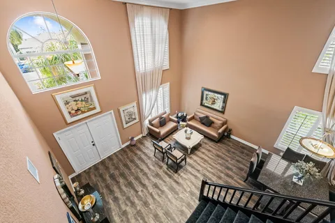 a kitchen with stainless steel appliances granite countertop a stove top oven a sink dishwasher a dining table and chairs with wooden floor
