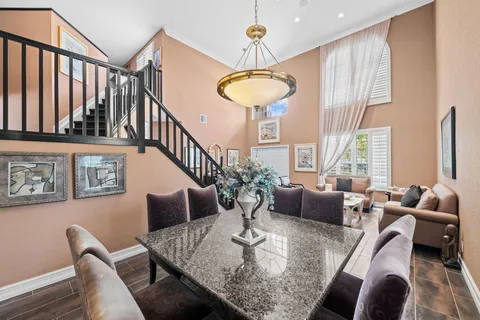 a dining area with a table chairs and a kitchen view
