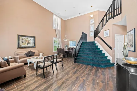 a kitchen with stainless steel appliances granite countertop a stove top oven a sink dishwasher a dining table and chairs with wooden floor