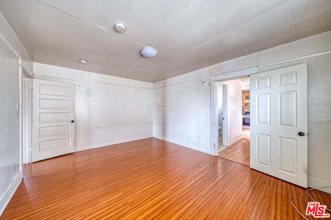 1677 South Harvard Boulevard, Unit UPSTAIRS Los Angeles, CA 90006 - Photo 11 of 19 a view of empty room with wooden floor and entryway
