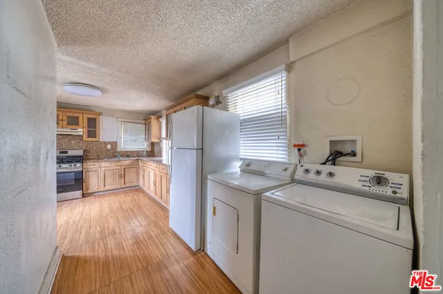 a kitchen with a sink cabinets stainless steel appliances and a window