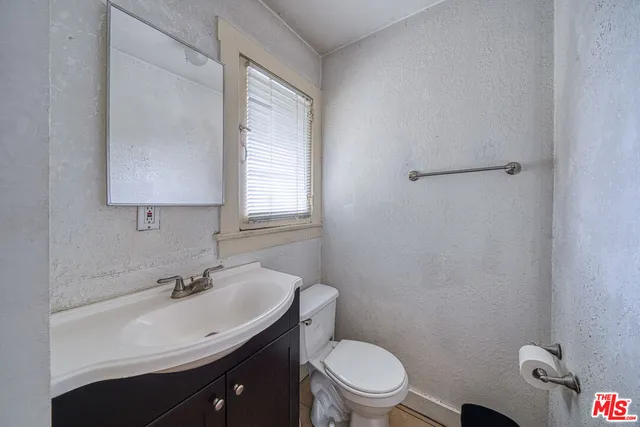 a bathroom with a sink toilet and vanity