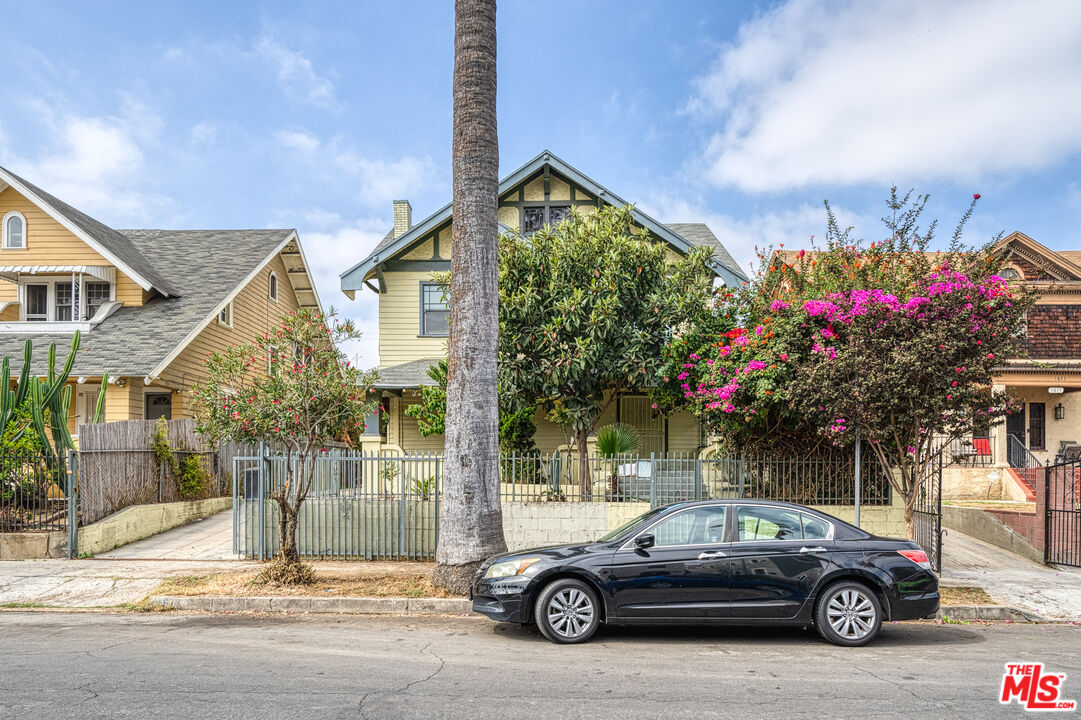1677 South Harvard Boulevard, Unit UPSTAIRS Los Angeles, CA 90006 - Photo 19 of 19 a car parked in front of a house