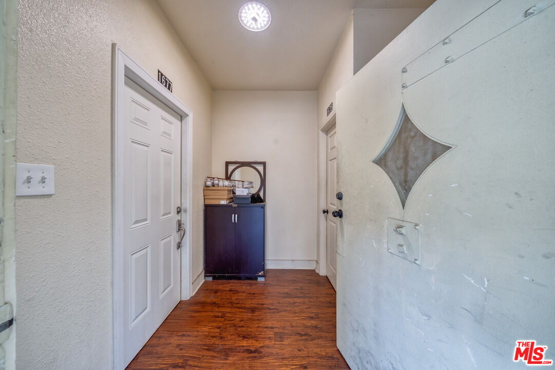 1677 South Harvard Boulevard, Unit UPSTAIRS Los Angeles, CA 90006 - Photo 6 of 19 a view of a hallway view with wooden floor and staircase