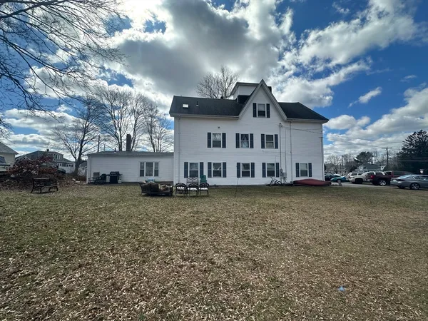 a view of a house with a large tree and a big yard