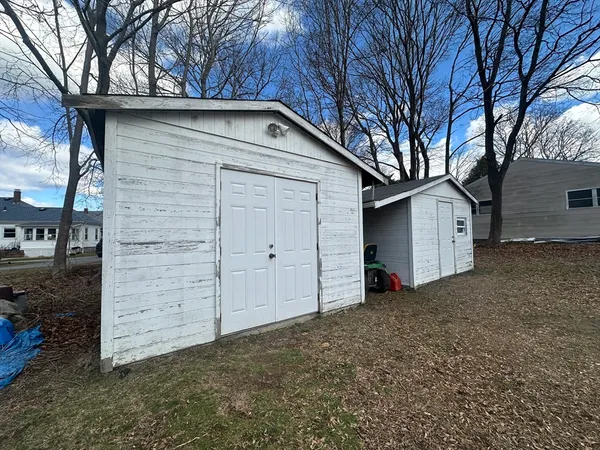 a view of a house with a yard and garage