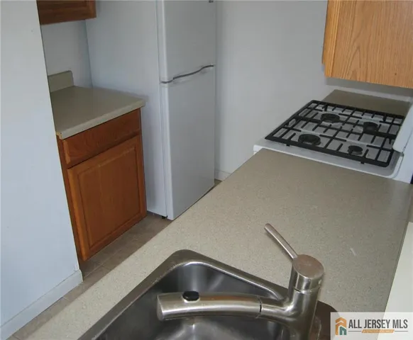 a kitchen with cabinets and a stove top oven