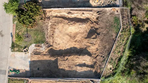 a view of a yard with wooden fence