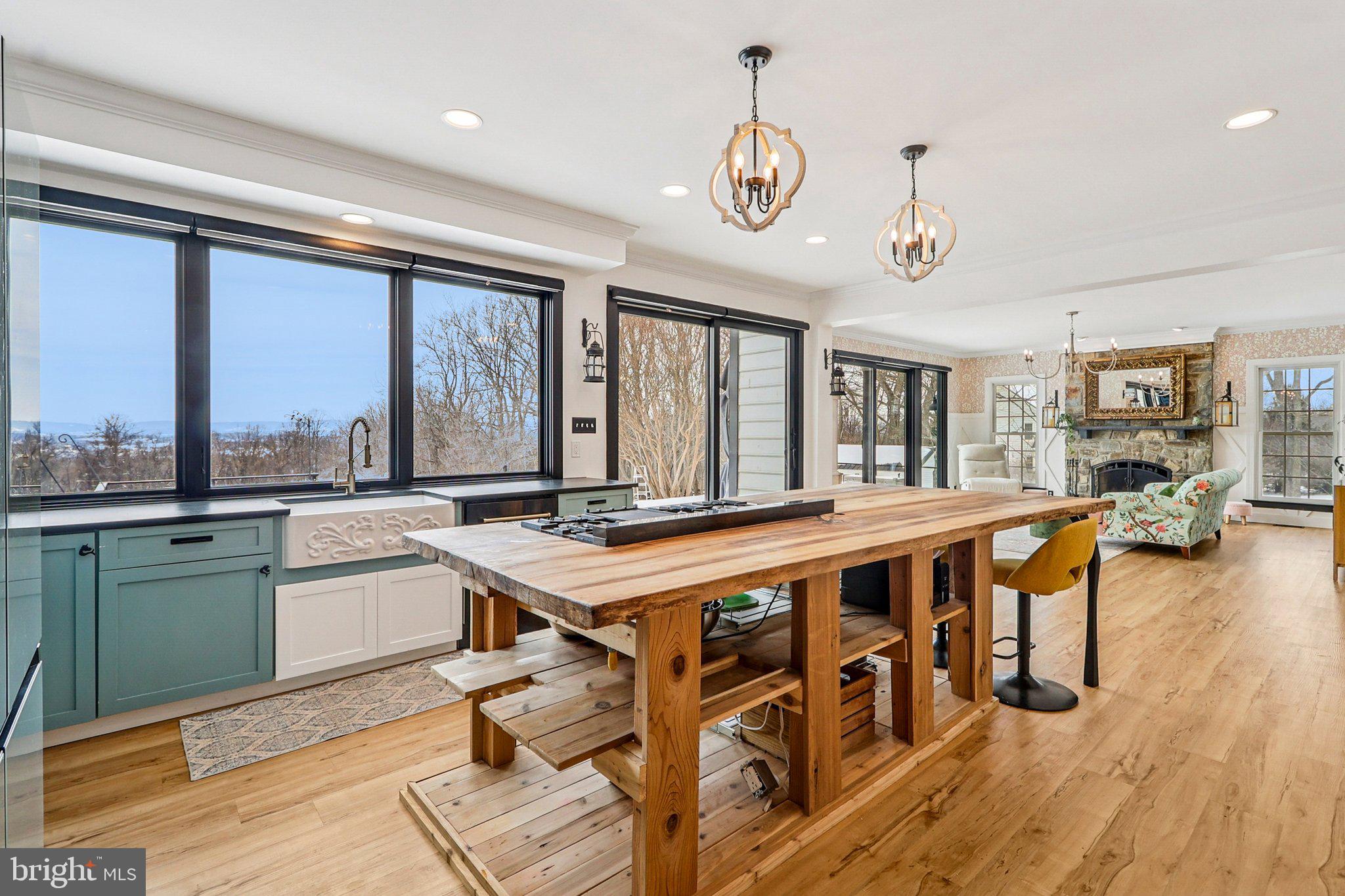 19075 Foxgreen Circle Leesburg, VA 20175 - Photo 16 of 71 a large white kitchen with a table and chairs