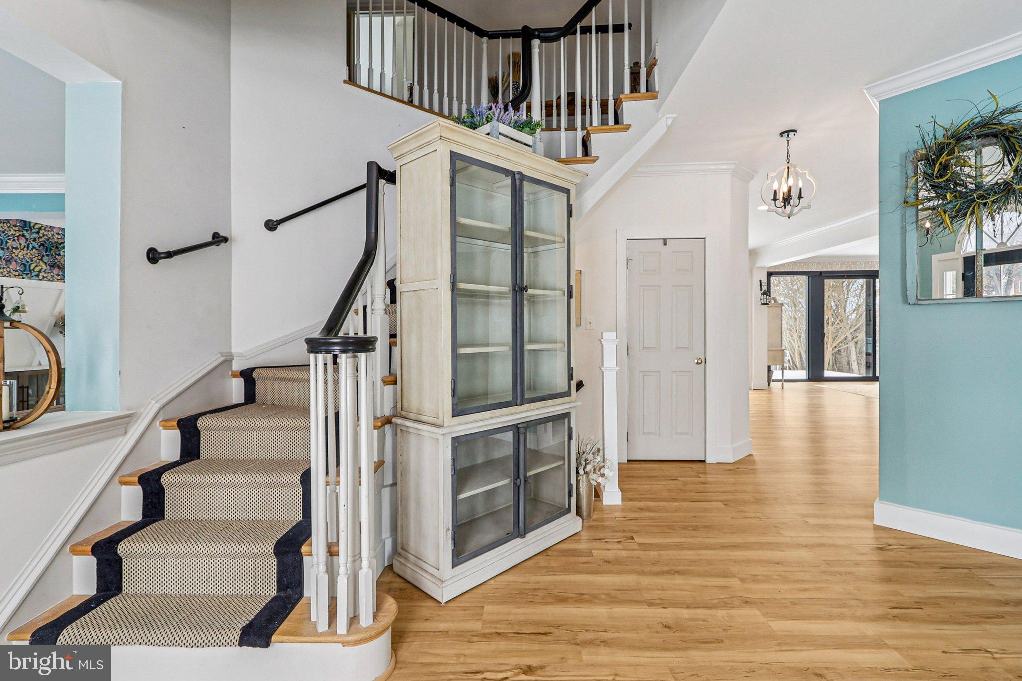 19075 Foxgreen Circle Leesburg, VA 20175 - Photo 26 of 71 a view of staircase with wooden floor and a chandelier