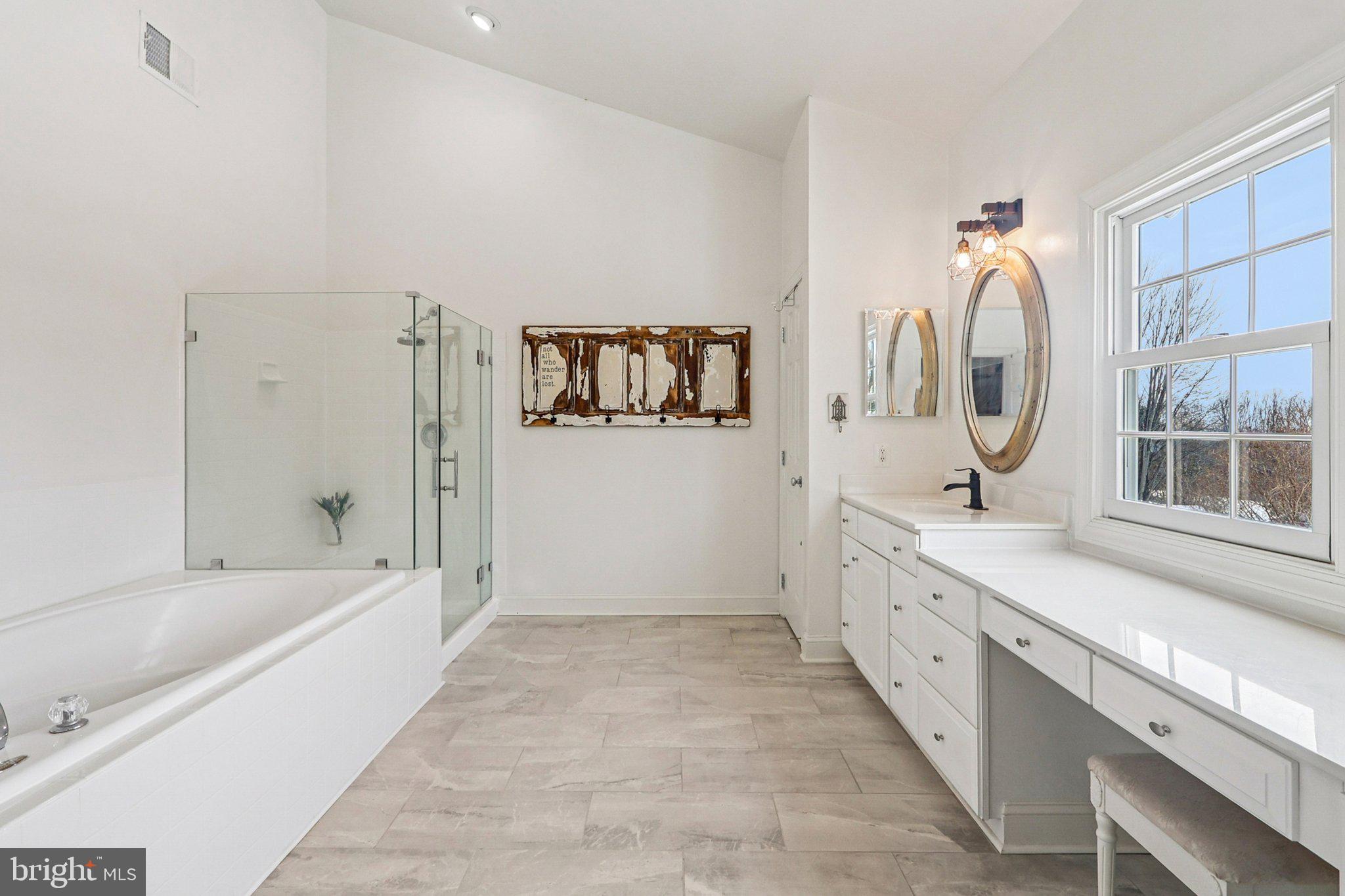 19075 Foxgreen Circle Leesburg, VA 20175 - Photo 34 of 71 a spacious bathroom with a tub sink and mirror