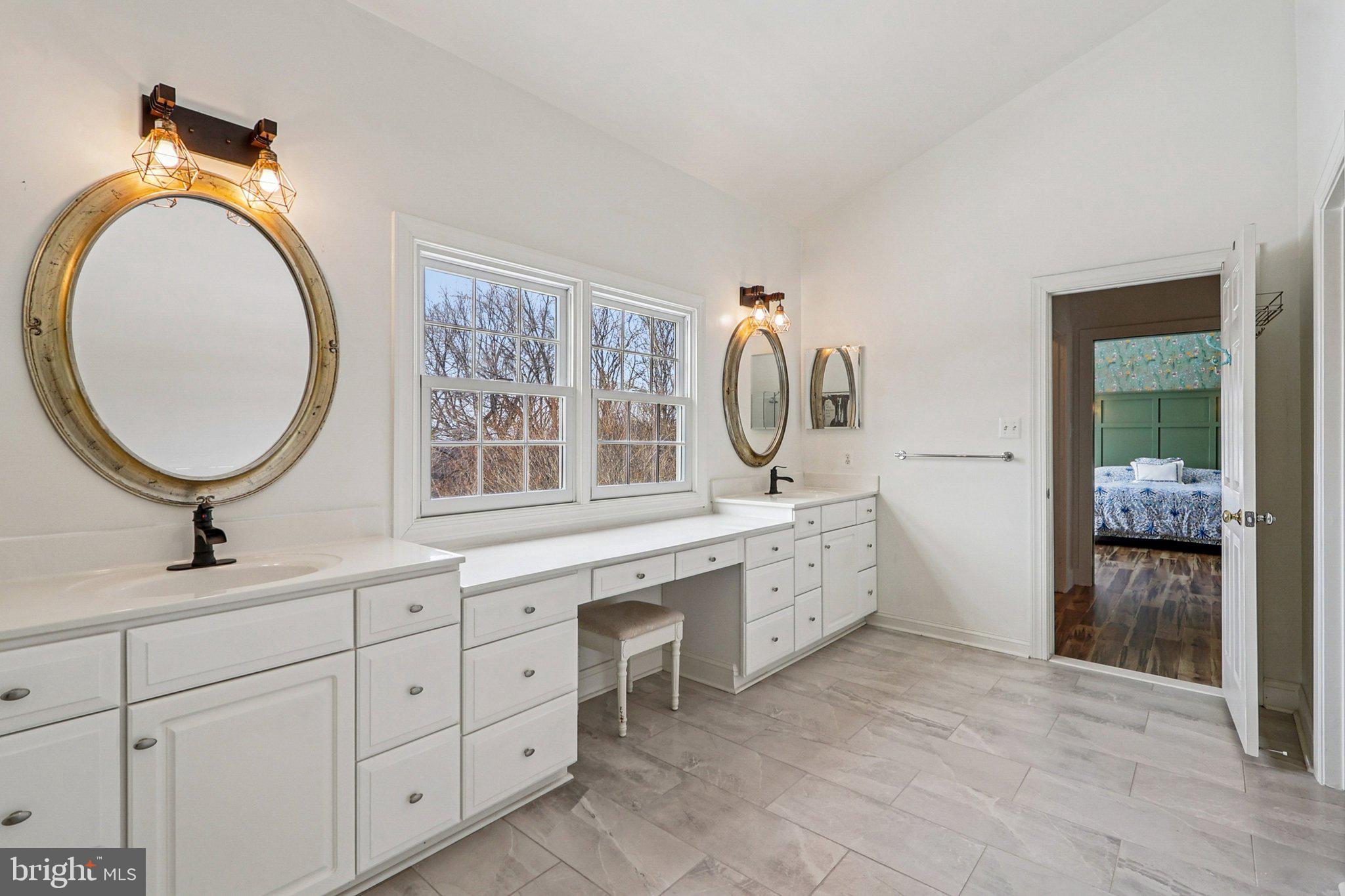 19075 Foxgreen Circle Leesburg, VA 20175 - Photo 35 of 71 a spacious bathroom with a double vanity sink and a mirror
