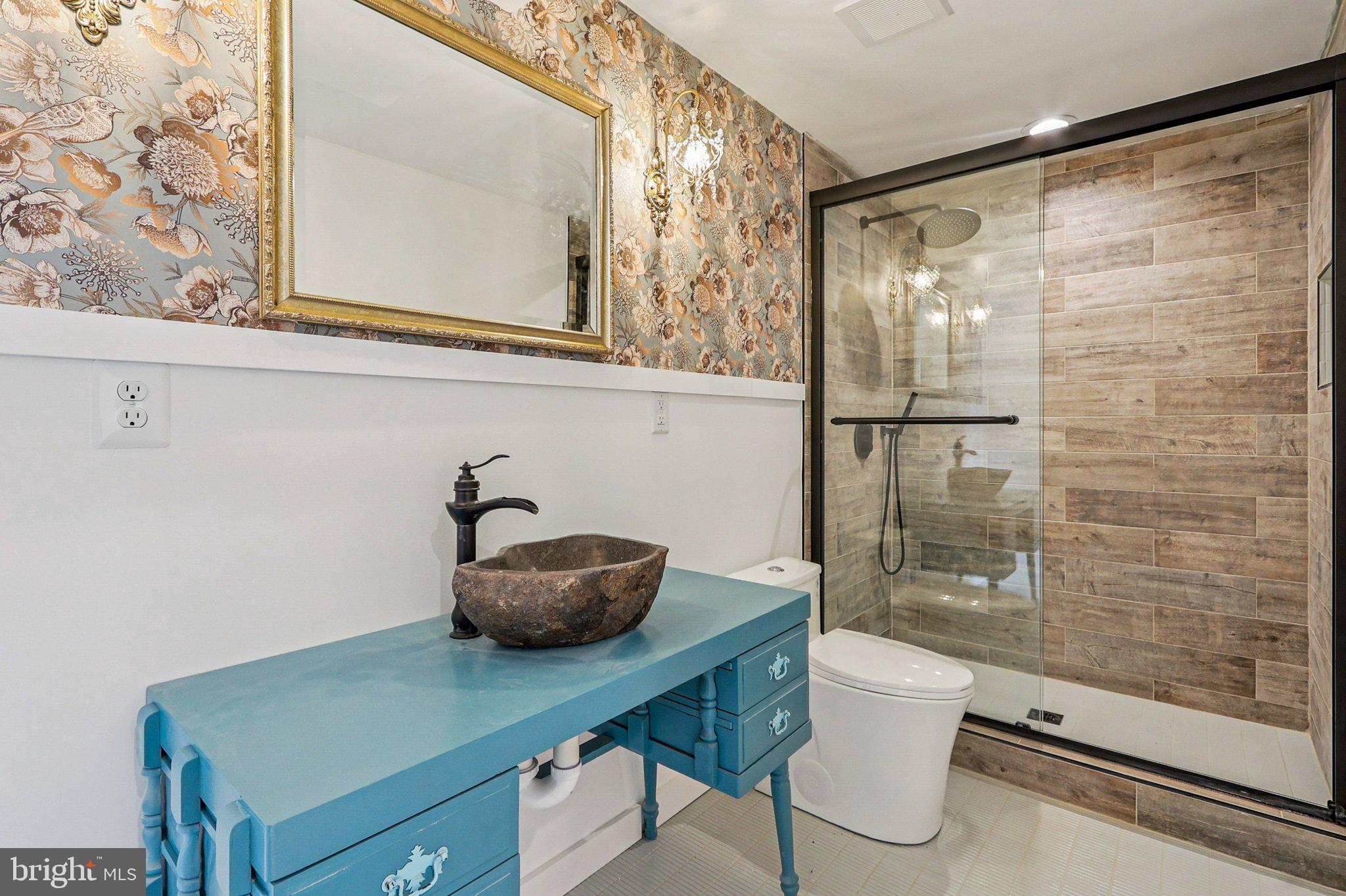 19075 Foxgreen Circle Leesburg, VA 20175 - Photo 59 of 71 a bathroom with a granite countertop sink a toilet a mirror and shower