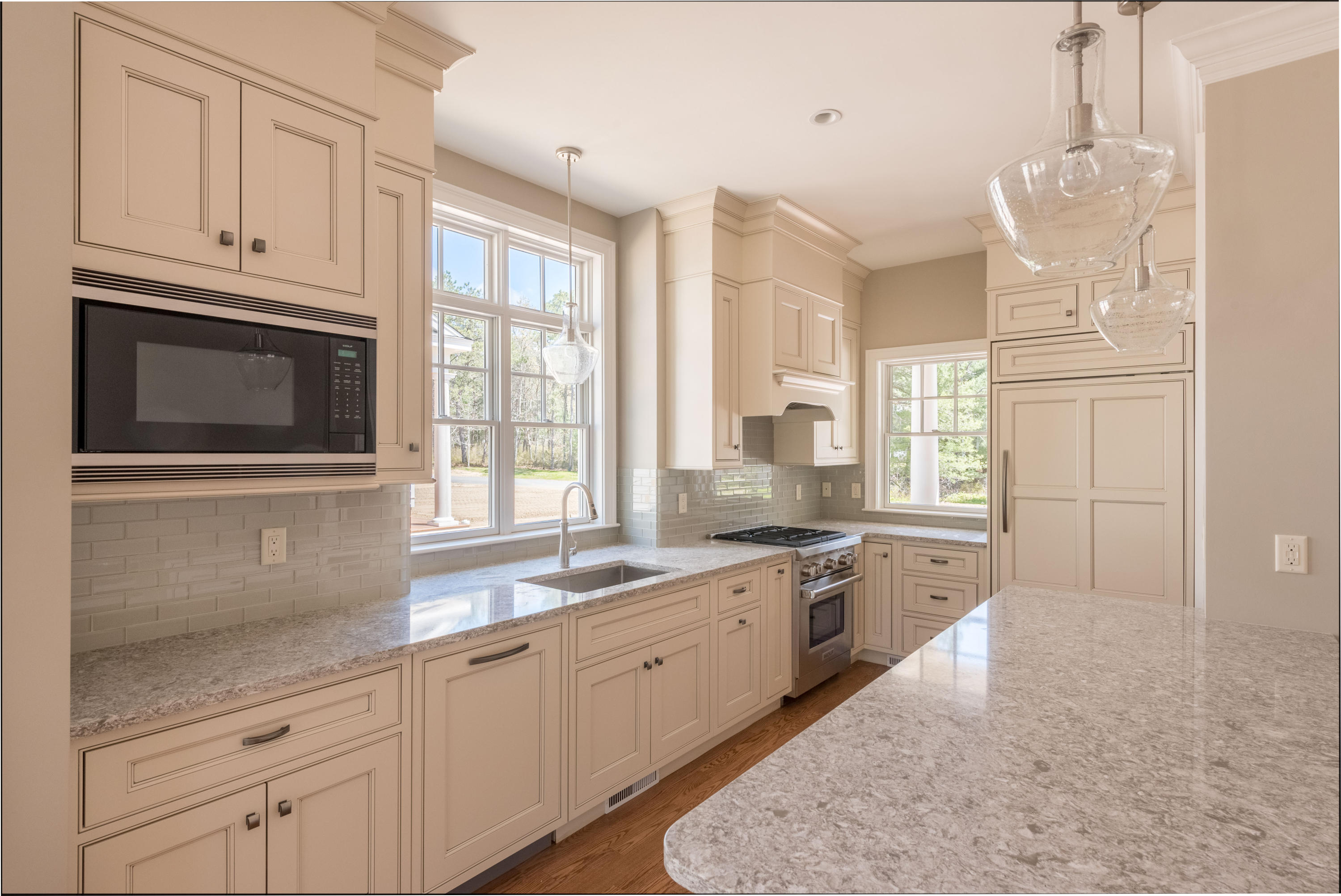 40 Clayton Circle, Unit B Mashpee, MA 02649 - Photo 4 of 11 a kitchen with granite countertop white cabinets stainless steel appliances a sink and a window