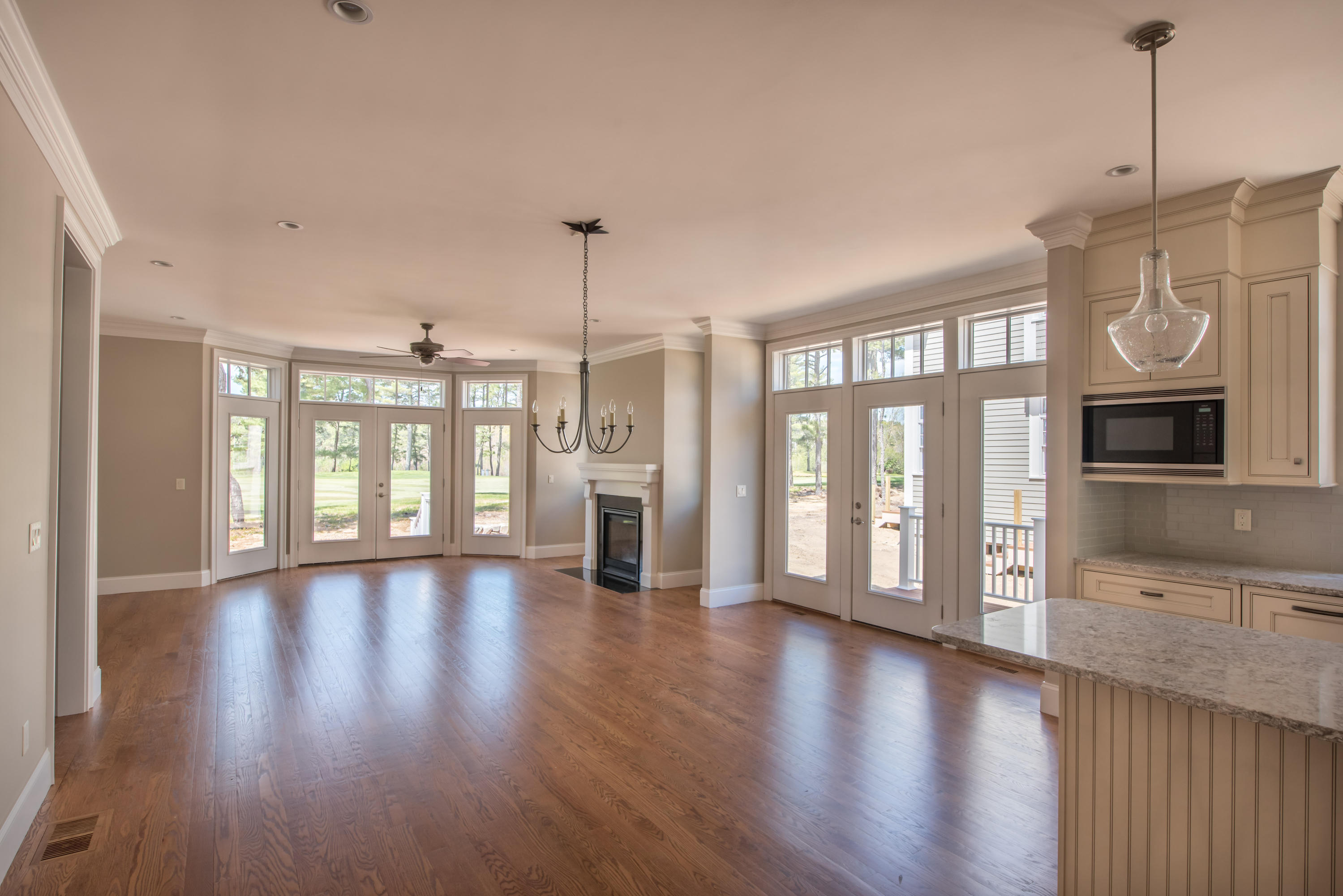 40 Clayton Circle, Unit B Mashpee, MA 02649 - Photo 5 of 11 a view of an empty room with wooden floor and a window