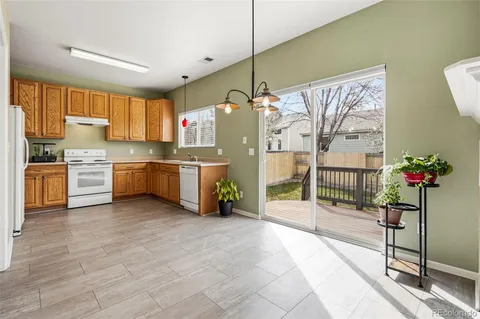 a open kitchen with stainless steel appliances granite countertop a stove and a refrigerator