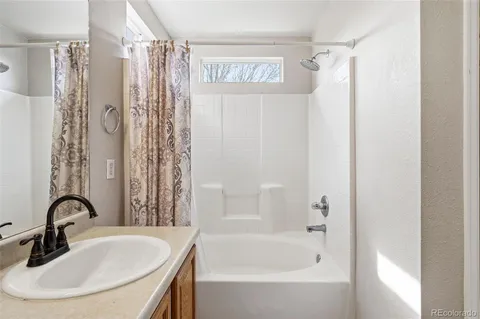 a bathroom with a shower curtain and a sink