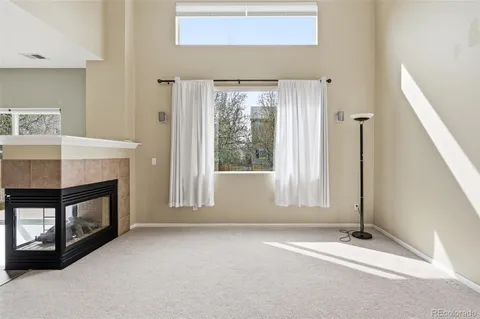a view of an empty room with a fireplace