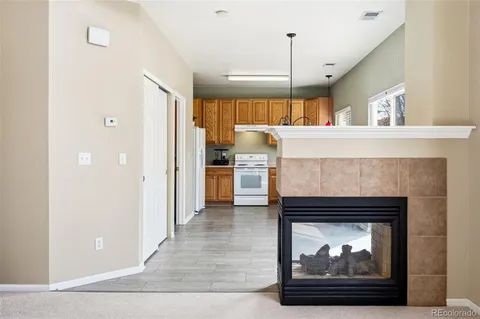 a open kitchen view with fireplace and wooden floor
