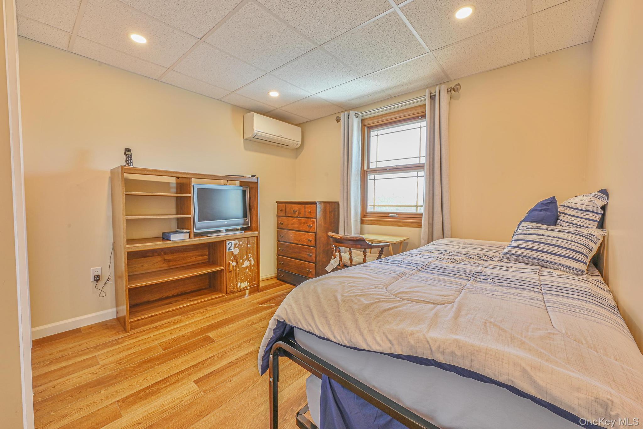 20 West 18th Road Queens, NY 11693 - Photo 30 of 41 a bedroom with a bed and a flat screen tv