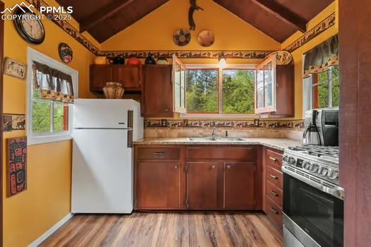 6015 Sioux Trail Cascade, CO 80809 - Photo 13 of 42 a kitchen with a stove a sink and a refrigerator