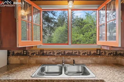 6015 Sioux Trail Cascade, CO 80809 - Photo 16 of 42 a kitchen with a sink and a window
