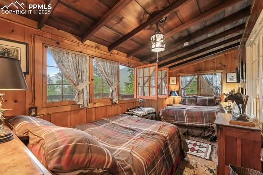 6015 Sioux Trail Cascade, CO 80809 - Photo 18 of 42 a bed sitting in a bedroom next to a large window