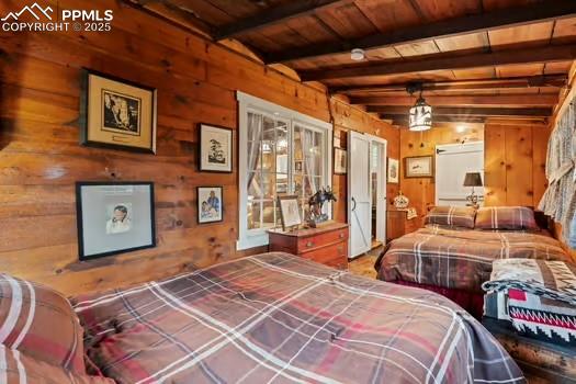 6015 Sioux Trail Cascade, CO 80809 - Photo 19 of 42 a bedroom with bed and wooden floor