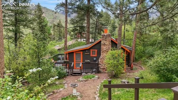 6015 Sioux Trail Cascade, CO 80809 - Photo 2 of 42 front view of a house with a tree