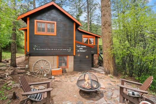 6015 Sioux Trail Cascade, CO 80809 - Photo 24 of 42 a view of a chairs and table in backyard